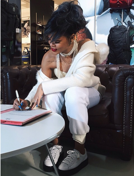 Rihanna signs the dotted line